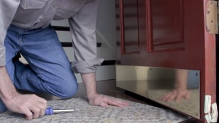 Home Handyman Installing A Front Door Kick Plate Stock Video