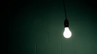 Abstract Swinging Light Bulb in Dark Room Stock Video Footage - VideoBlocks